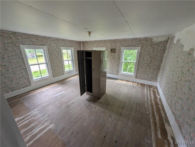 1 Shults Ave, Cohocton, NY 14826 - unfurnished bedroom with wood-type flooring, wallpapered walls, and baseboards