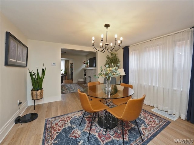 3912 Seneca St Unit 1, West Seneca, NY 14224 - dining room with wood finished floors, a chandelier, and baseboards