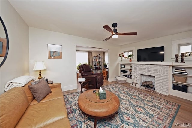 3912 Seneca St Unit 1, West Seneca, NY 14224 - living room featuring a brick fireplace, a ceiling fan, wood finished floors, and baseboards