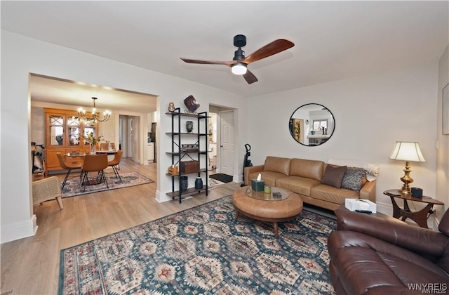 3912 Seneca St Unit 1, West Seneca, NY 14224 - living room featuring a chandelier, a ceiling fan, light wood finished floors, and baseboards