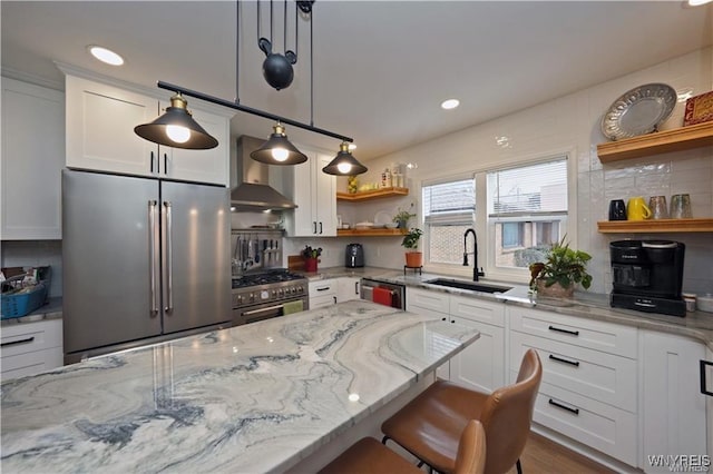 3912 Seneca St Unit 1, West Seneca, NY 14224 - kitchen featuring premium appliances, open shelves, a sink, wall chimney range hood, and white cabinets