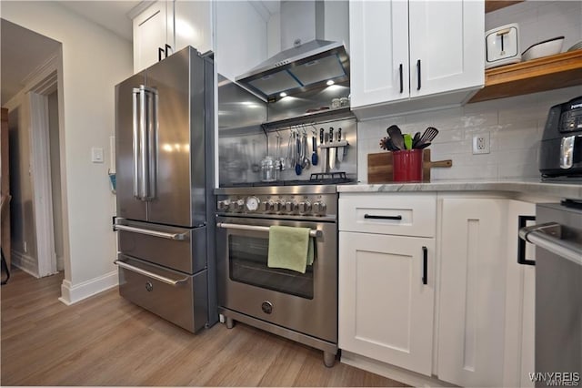 3912 Seneca St Unit 1, West Seneca, NY 14224 - kitchen featuring stainless steel appliances, light wood-type flooring, light countertops, tasteful backsplash, and white cabinets