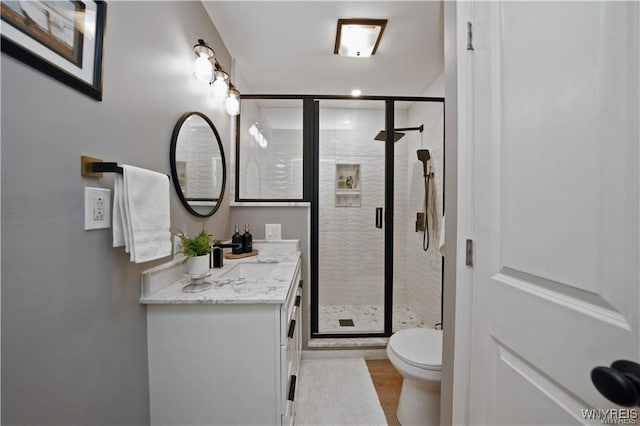 3912 Seneca St Unit 1, West Seneca, NY 14224 - bathroom featuring vanity, toilet, a stall shower, and wood finished floors