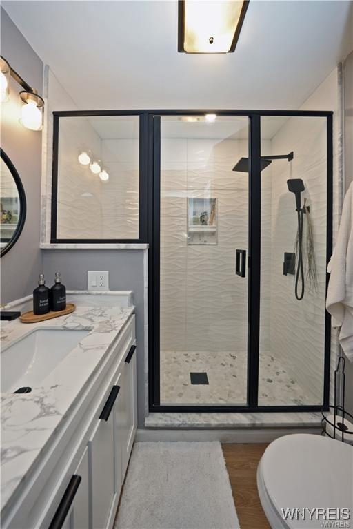 3912 Seneca St Unit 1, West Seneca, NY 14224 - full bathroom with vanity, a shower stall, and wood finished floors