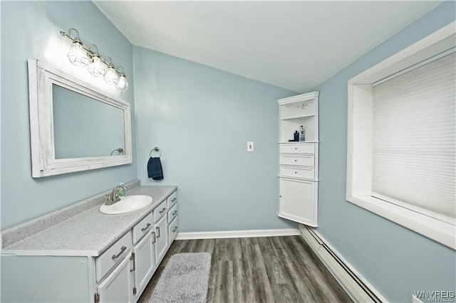 3912 Seneca St Unit 1, West Seneca, NY 14224 - bathroom with wood finished floors, vanity, a baseboard heating unit, and baseboards