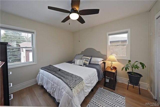 3912 Seneca St Unit 1, West Seneca, NY 14224 - bedroom featuring multiple windows, wood finished floors, baseboards, and a ceiling fan