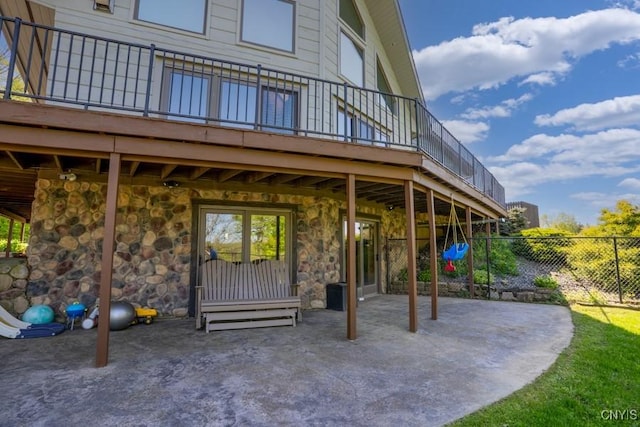 240 Mucky Run Rd, Frankfort, NY 13340 - view of exterior entry with stone siding, fence, a deck, and a patio area