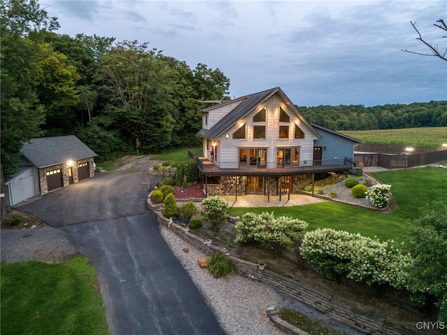 240 Mucky Run Rd, Frankfort, NY 13340 - rustic home featuring an outbuilding, a garage, a front lawn, a deck, and a view of trees
