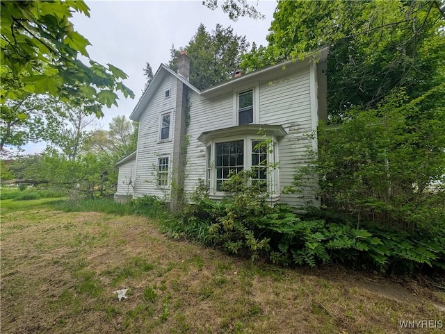 11 N Main St, Cohocton, NY 14826 - view of side of property featuring a chimney