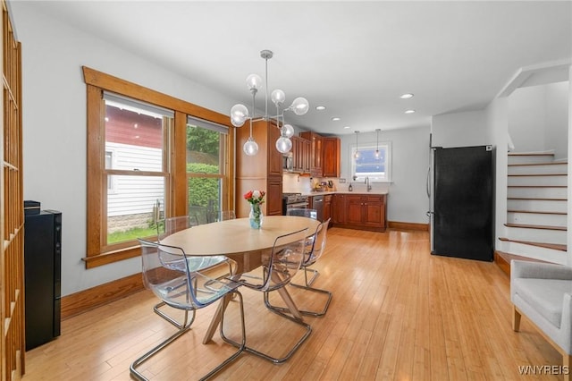 dining space featuring plenty of natural light, stairway, baseboards, light wood-style flooring, and recessed lighting