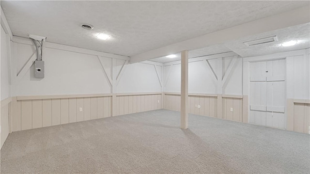 finished basement featuring carpet floors and electric panel