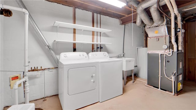 laundry area featuring separate washer and dryer, concrete block wall, and heating unit