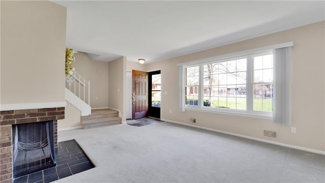 entryway featuring baseboards, stairs, and carpet