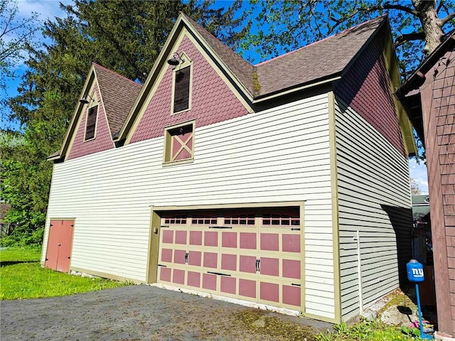440 Park Ave, Barton, NY 14892 - view of side of property featuring a shingled roof, an attached garage, and asphalt driveway