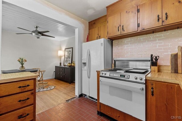 10 S Ten Eyck Ave, Cazenovia, NY 13035 - kitchen featuring white appliances, brick patterned flooring, light countertops, ceiling fan, and brown cabinets