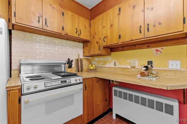 10 S Ten Eyck Ave, Cazenovia, NY 13035 - kitchen with white appliances, radiator, light countertops, and brick patterned floors