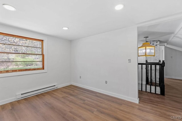 10 S Ten Eyck Ave, Cazenovia, NY 13035 - empty room with baseboard heating, wood finished floors, recessed lighting, baseboards, and vaulted ceiling