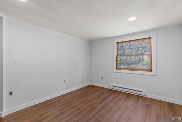 10 S Ten Eyck Ave, Cazenovia, NY 13035 - empty room featuring a baseboard radiator, wood finished floors, baseboards, and recessed lighting