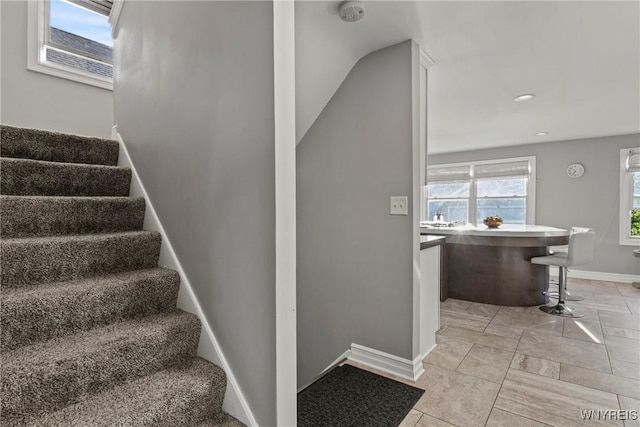 stairs featuring baseboards and recessed lighting
