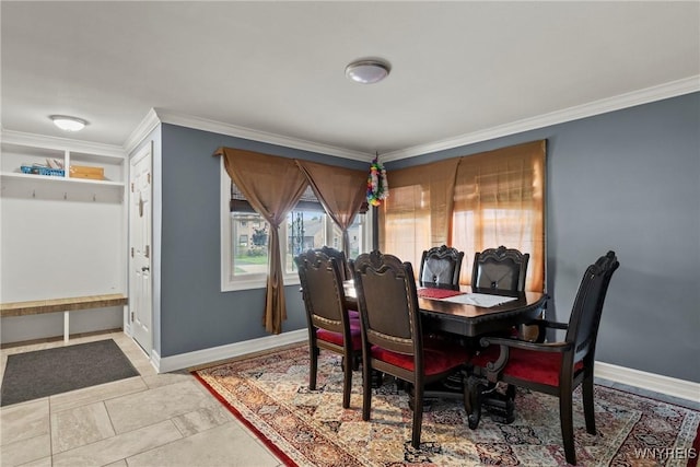 dining area with ornamental molding and baseboards