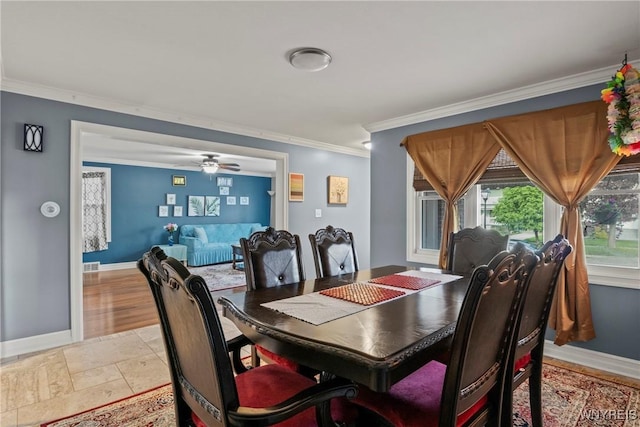dining area with crown molding, baseboards, and a ceiling fan