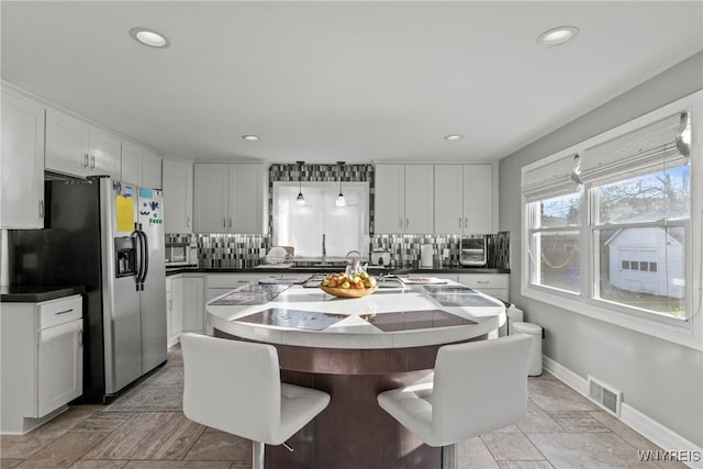 dining room featuring recessed lighting and baseboards