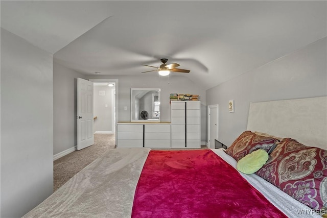 bedroom featuring carpet floors, vaulted ceiling, a ceiling fan, and baseboards