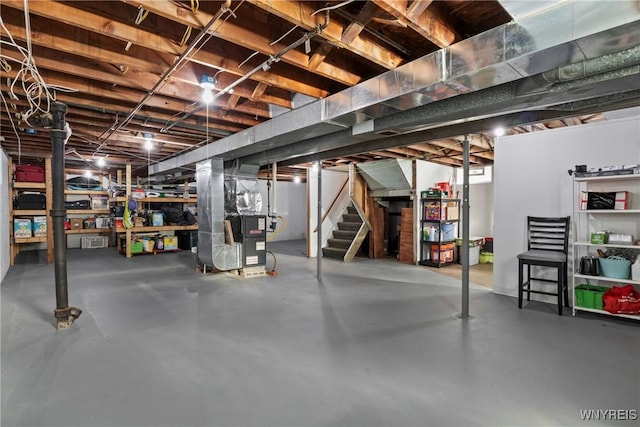 unfinished basement with stairway and heating unit