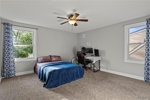 carpeted bedroom featuring baseboards and a ceiling fan
