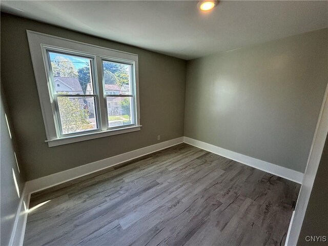 214 Herriman St Unit 216, Syracuse, NY 13204 - empty room with dark wood finished floors and baseboards