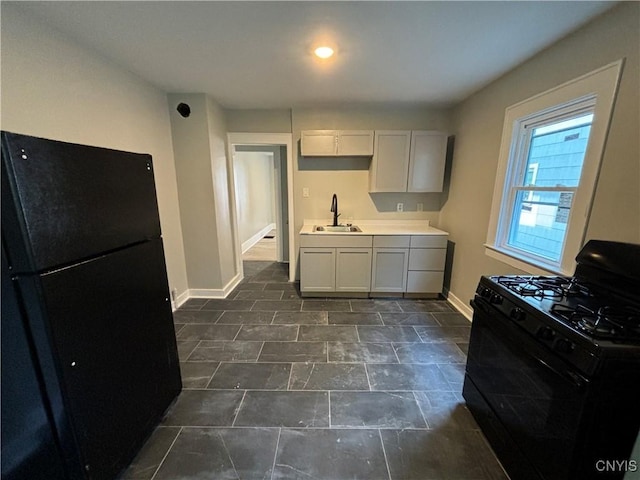 214 Herriman St Unit 216, Syracuse, NY 13204 - kitchen featuring black appliances, baseboards, a sink, and light countertops