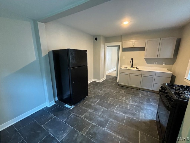 214 Herriman St Unit 216, Syracuse, NY 13204 - kitchen with black appliances, a sink, baseboards, light countertops, and dark stone finish flooring