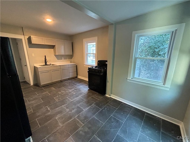 214 Herriman St Unit 216, Syracuse, NY 13204 - kitchen with black gas range, a sink, baseboards, light countertops, and recessed lighting