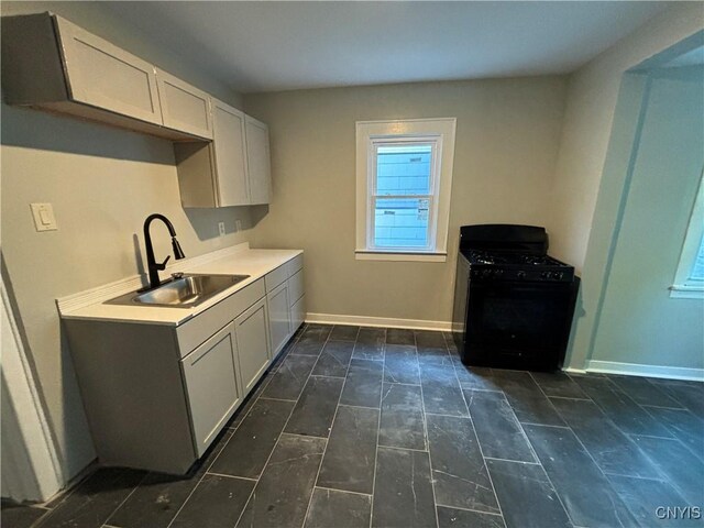 214 Herriman St Unit 216, Syracuse, NY 13204 - kitchen featuring black range with gas cooktop, a sink, baseboards, and light countertops