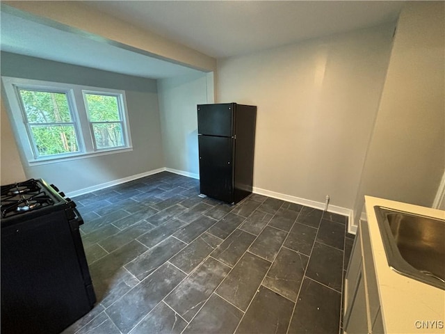 214 Herriman St Unit 216, Syracuse, NY 13204 - kitchen with black appliances, baseboards, and a sink