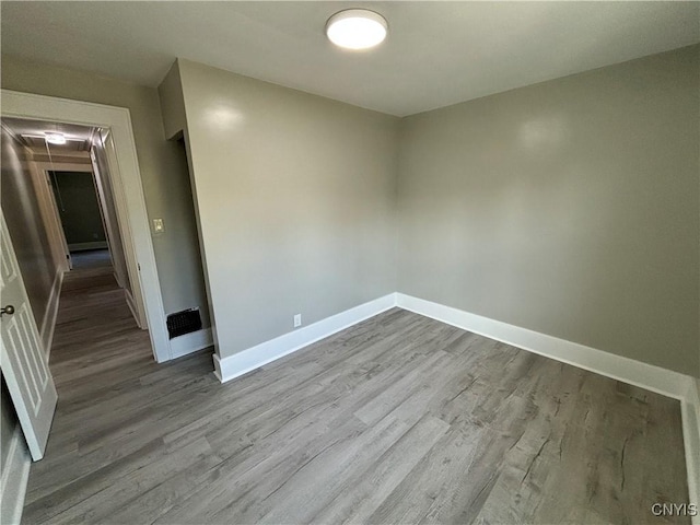 214 Herriman St Unit 216, Syracuse, NY 13204 - empty room featuring wood finished floors, baseboards, and attic access