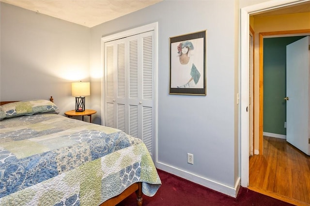 bedroom with baseboards, a closet, and wood finished floors