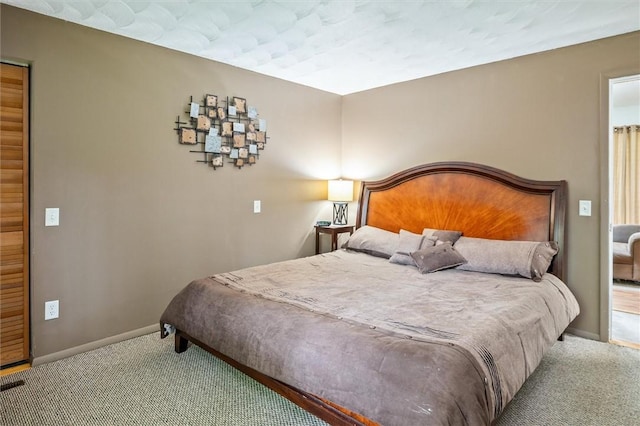 bedroom with carpet and baseboards