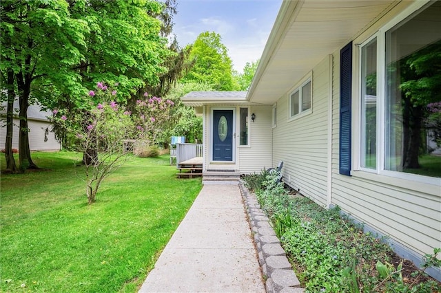 entrance to property featuring a yard