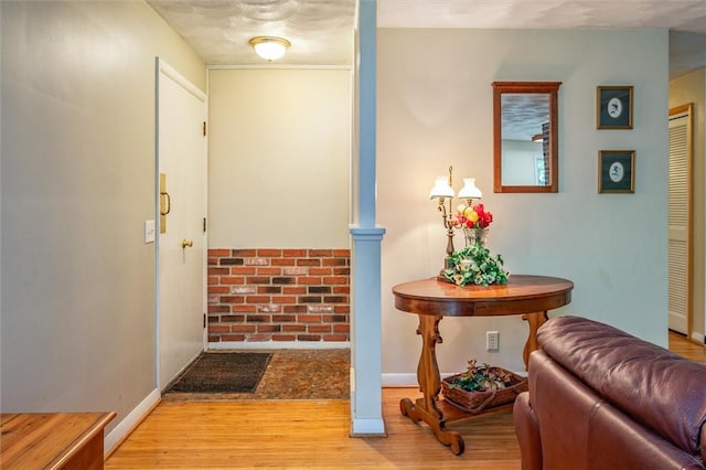 corridor with wood finished floors and baseboards