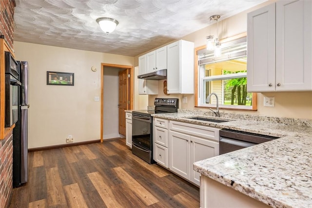 kitchen with black appliances, a sink, under cabinet range hood, dark wood-style floors, and light stone countertops