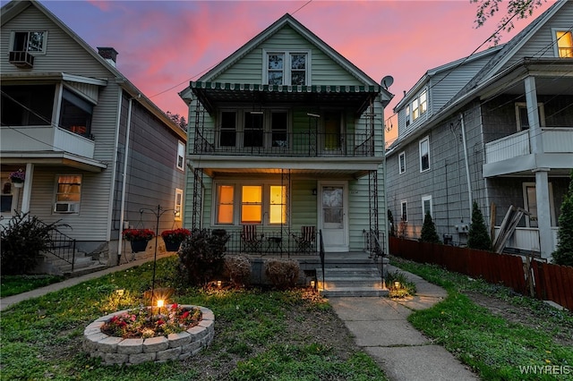 2254 Grand Ave, Niagara Falls, NY 14301 - view of front of property with a fire pit, covered porch, a balcony, fence, and cooling unit