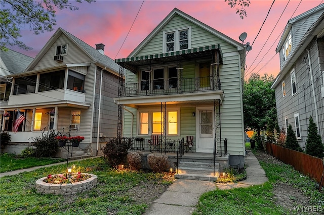 2254 Grand Ave, Niagara Falls, NY 14301 - view of front of house featuring covered porch, a balcony, and fence