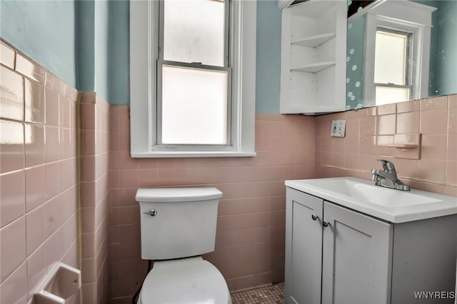 2254 Grand Ave, Niagara Falls, NY 14301 - half bathroom with tile walls, toilet, vanity, and wainscoting