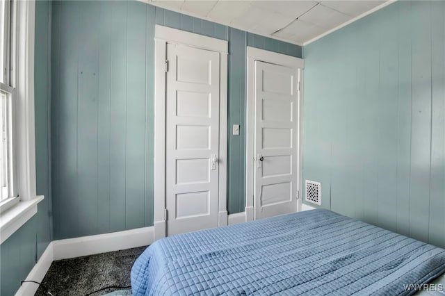 2254 Grand Ave, Niagara Falls, NY 14301 - carpeted bedroom featuring wood walls and baseboards