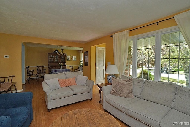 living area with a chandelier and wood finished floors