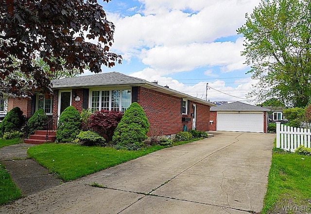 single story home featuring an outbuilding, brick siding, and a detached garage