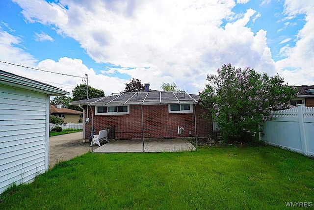 rear view of property featuring a patio and brick siding