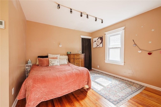 141 Mulberry St, Rochester, NY 14620 - bedroom with hardwood / wood-style floors, rail lighting, and baseboards