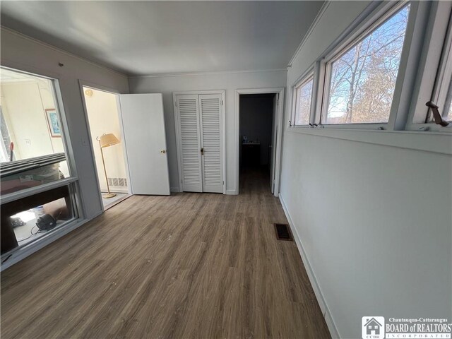 627 Genesee St, Olean-City, NY 14760 - unfurnished bedroom with crown molding, wood finished floors, baseboards, and a closet